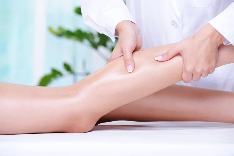 Therapist working on leg muscles for recovery